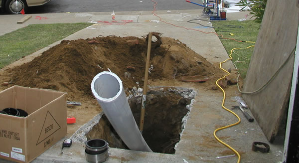 A plumber working on a trenchless sewer repair in Manchester, CT